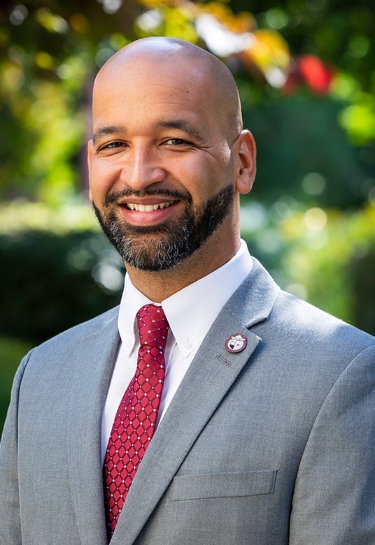 a man in a suit smiling