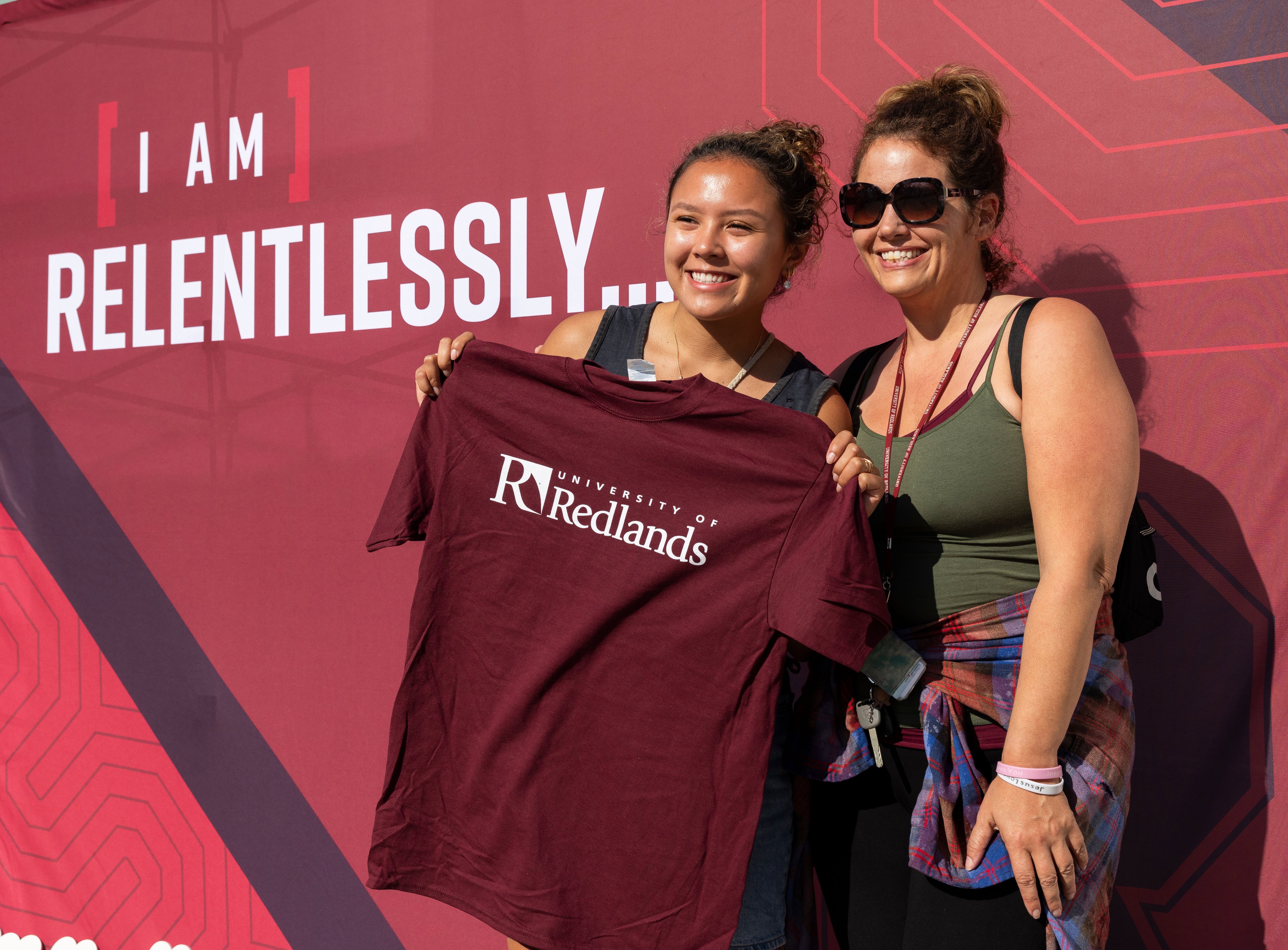 two women holding a shirt