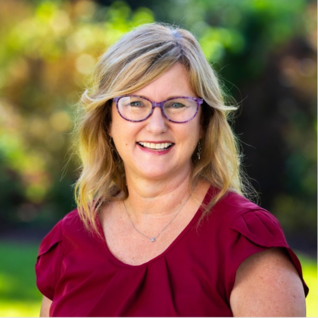 a woman wearing glasses and a red shirt