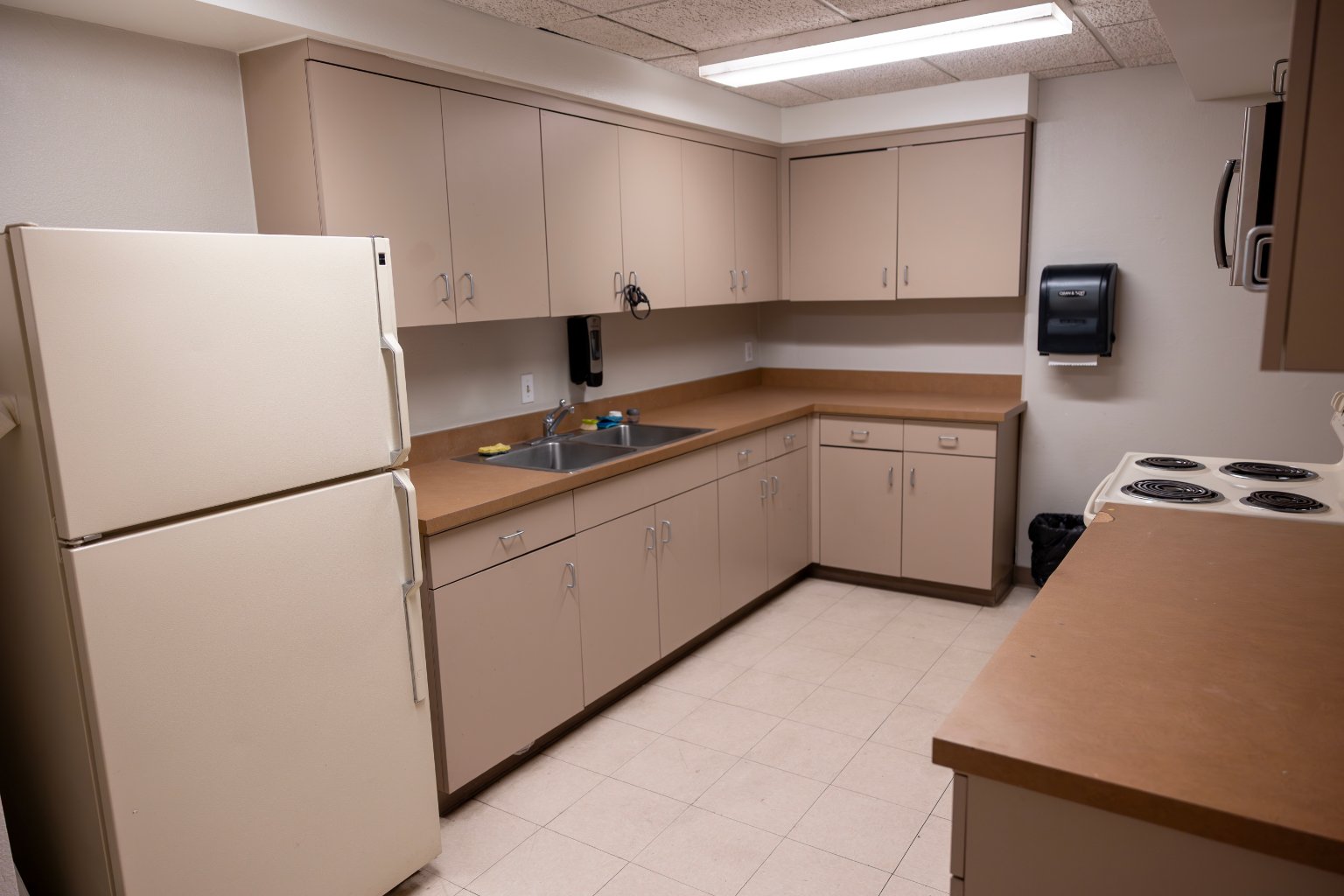 a kitchen with white cabinets and a sink