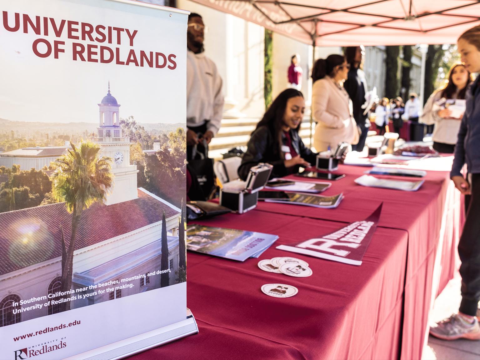a table with red tablecloths and a sign