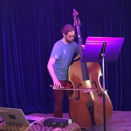 a man playing a double bass