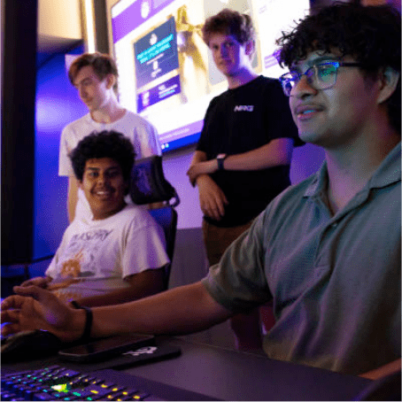 a group of people sitting at a computer