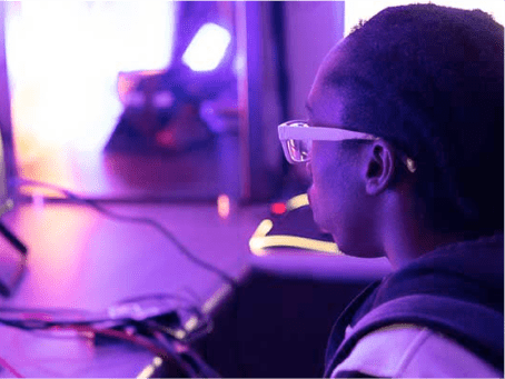 a person wearing glasses looking at a computer