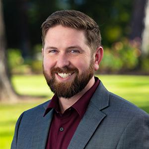 a man with a beard smiling