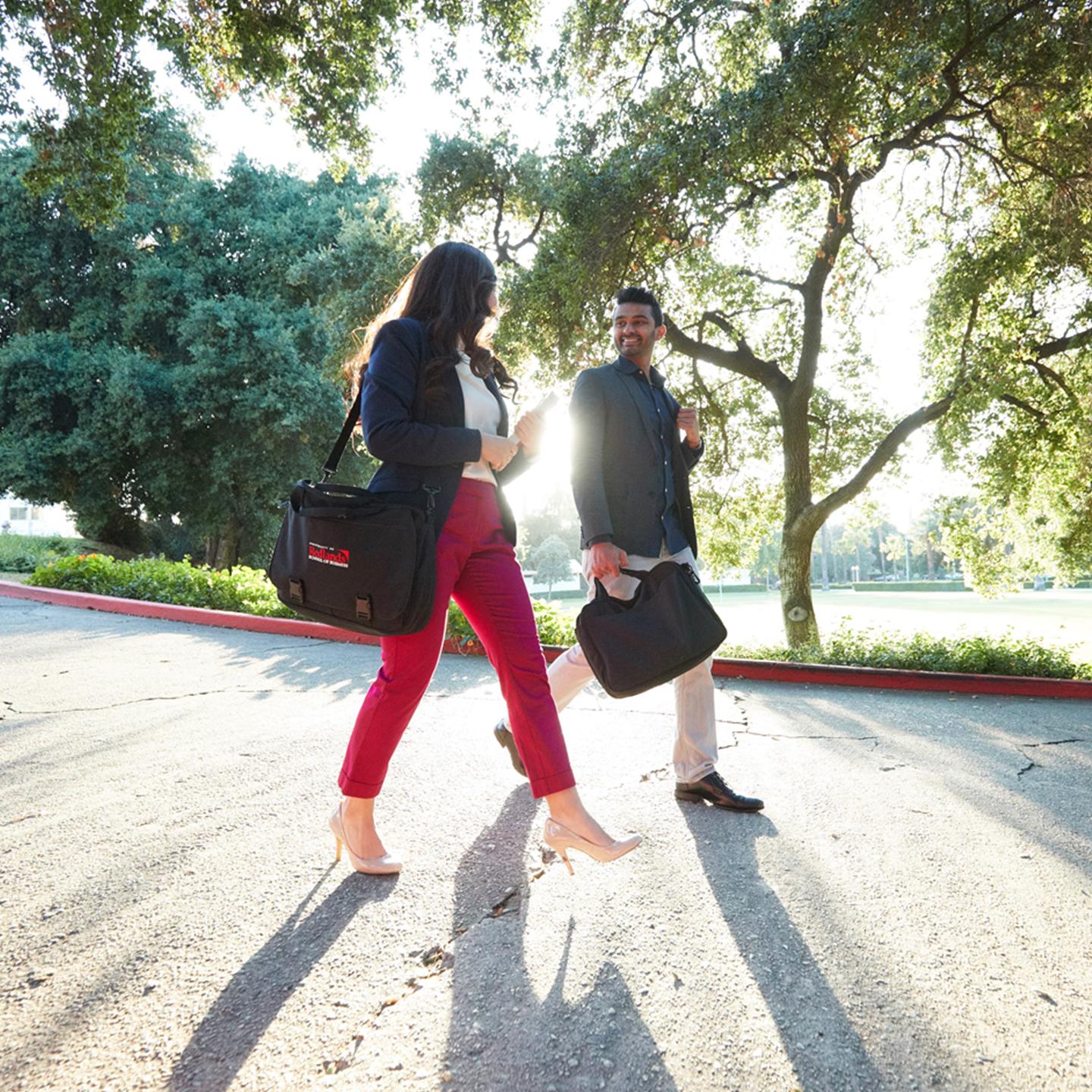 a man and woman walking on a street