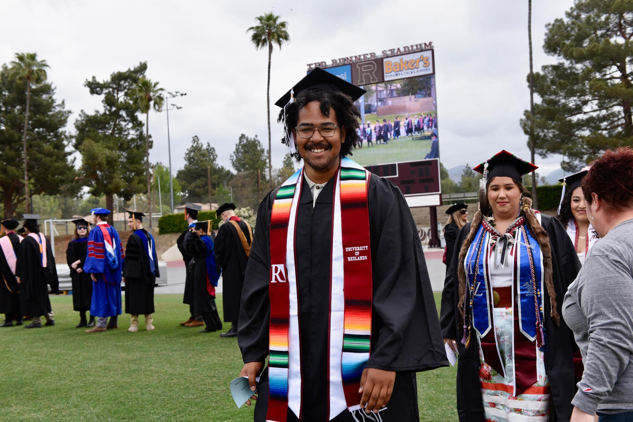 a man and woman in graduation gowns and caps