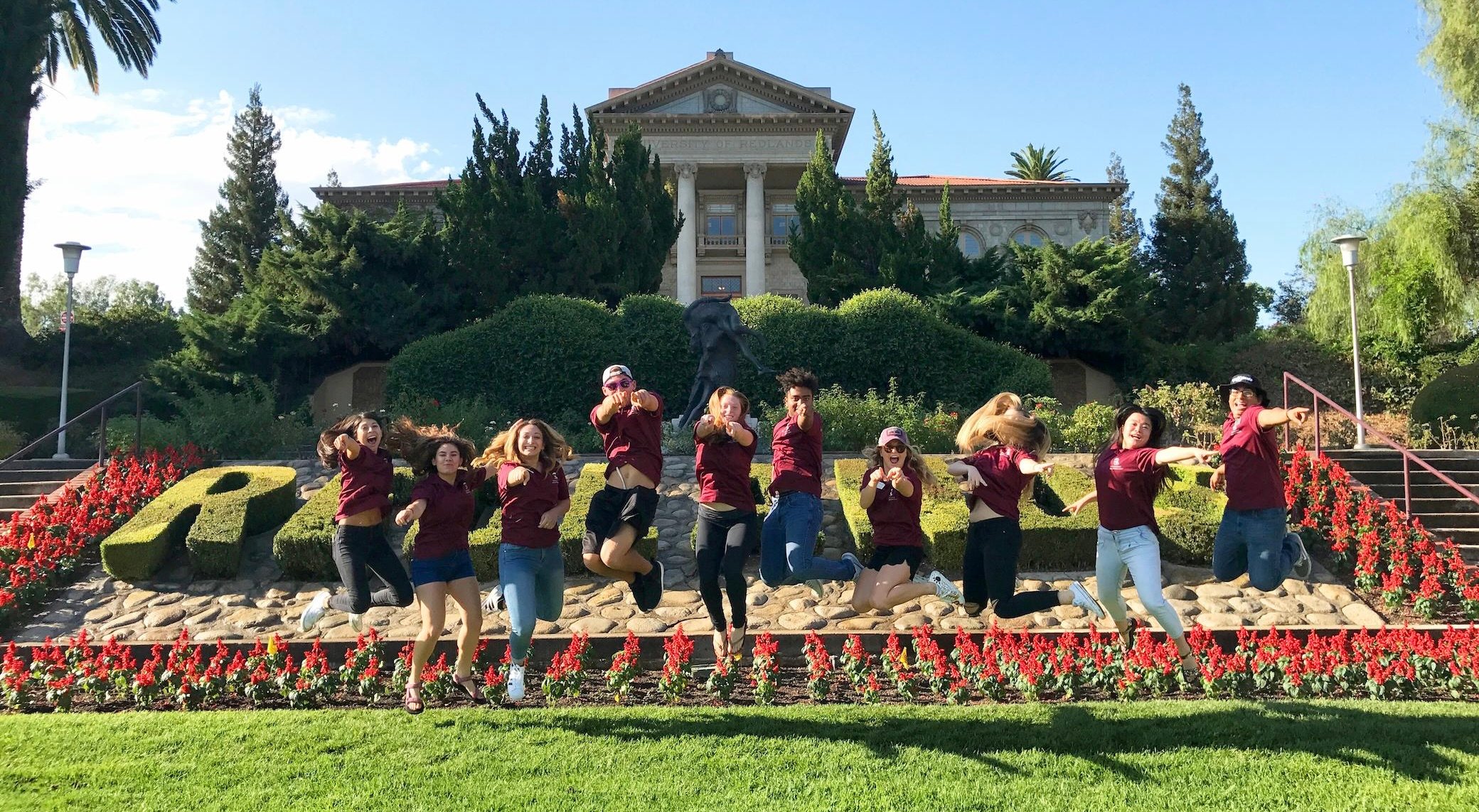 a group of people jumping in front of a building