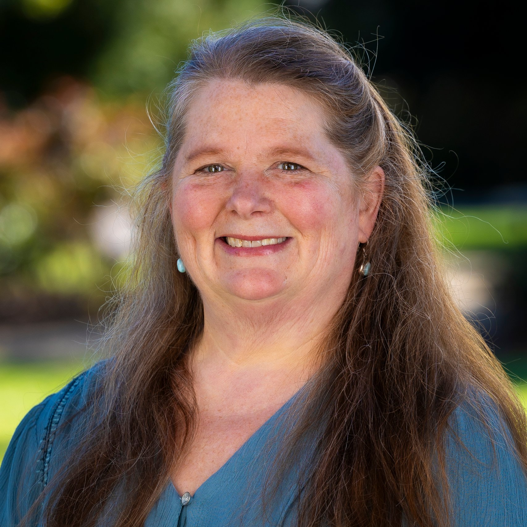 a woman with long hair smiling