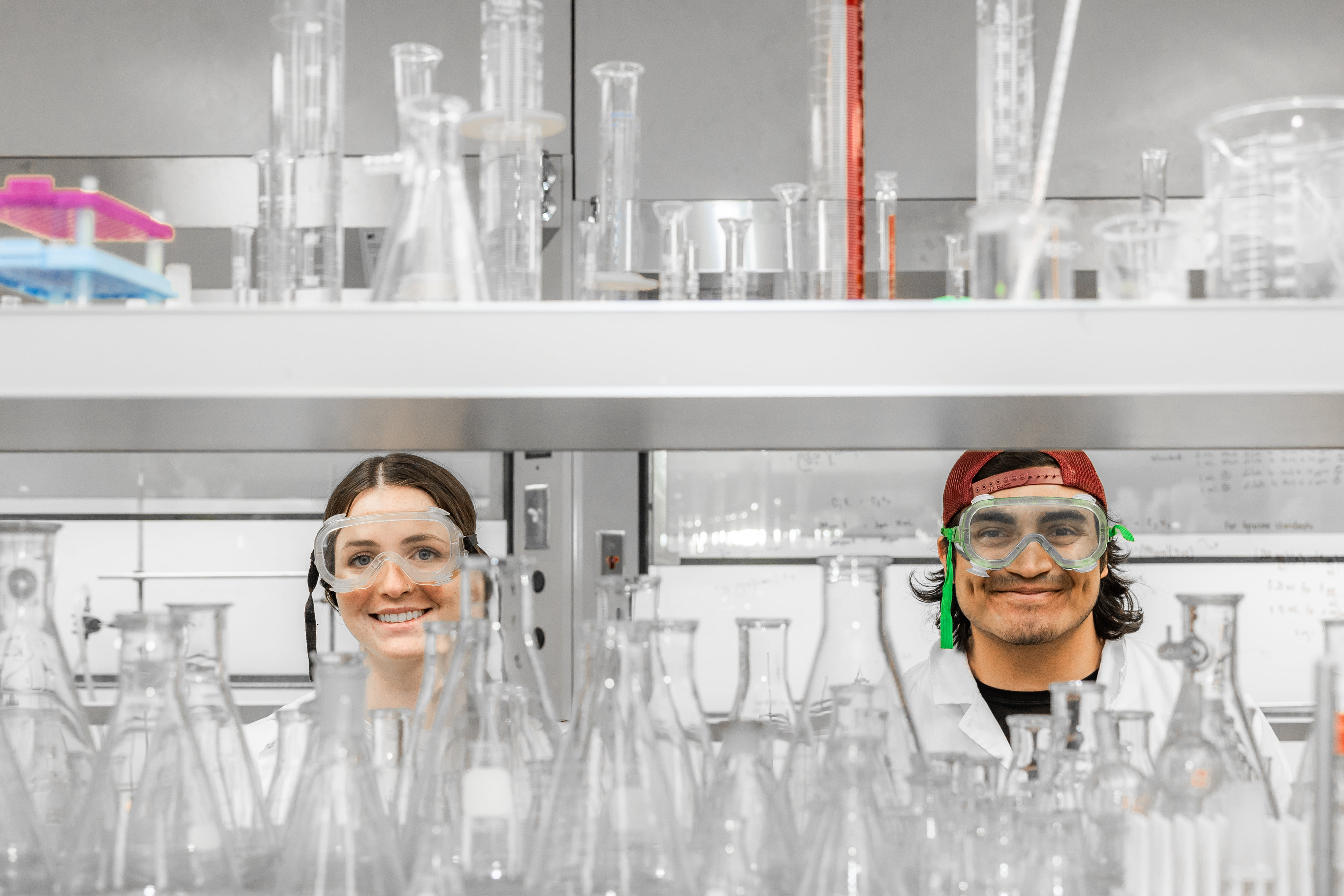 a man and woman in lab coats and goggles
