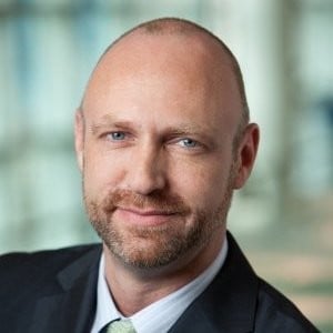 a man in a suit smiling