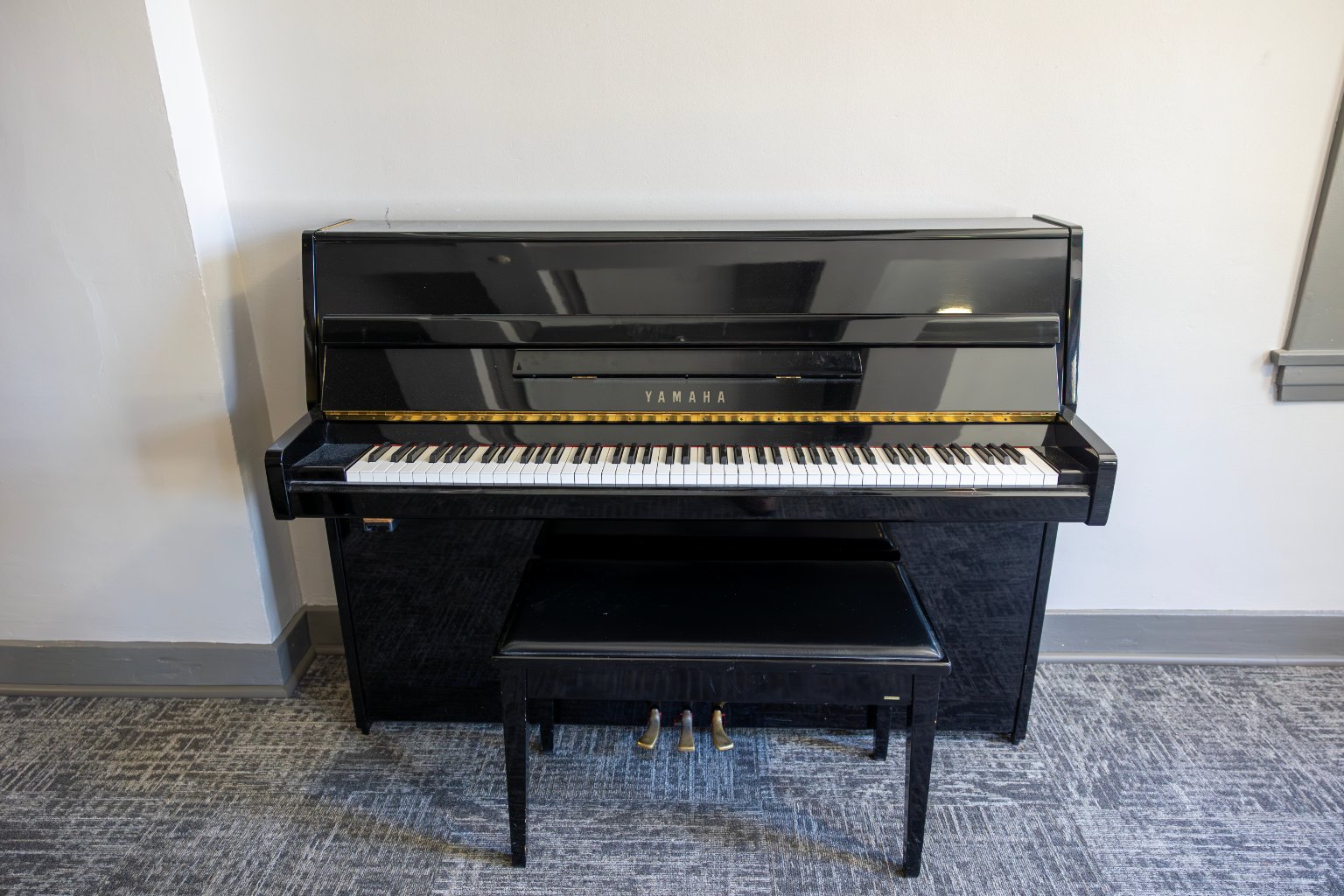 a piano with a bench in front of it