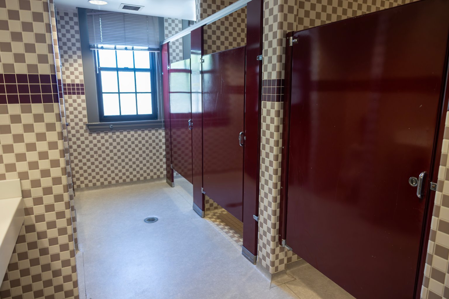a bathroom with red doors and a window
