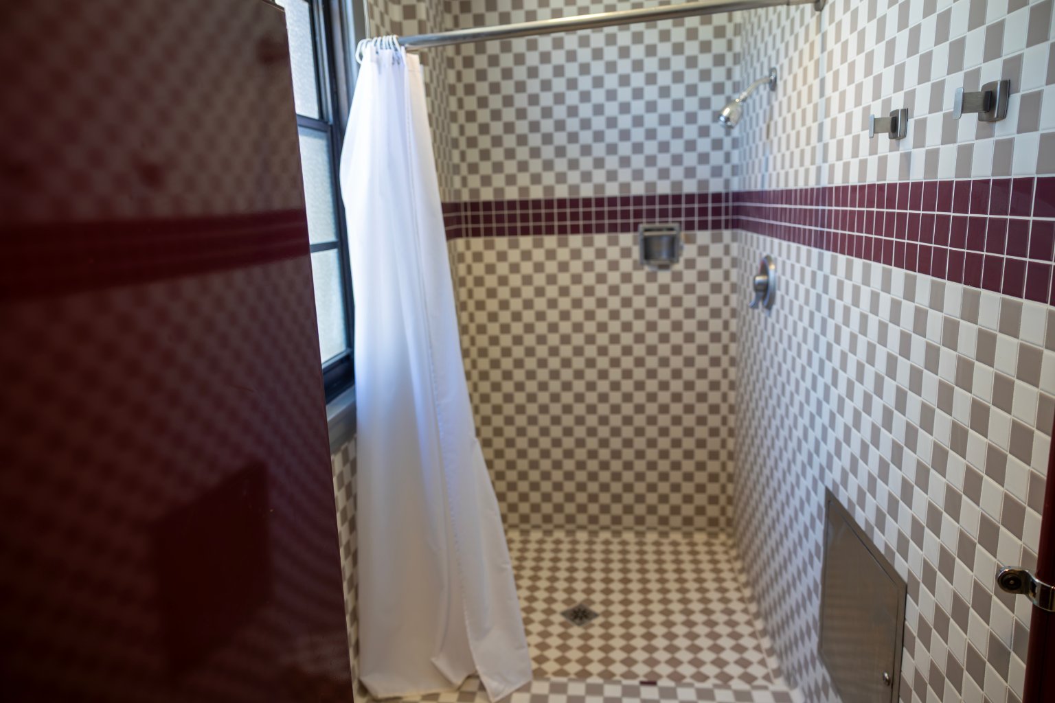 a shower with a white curtain