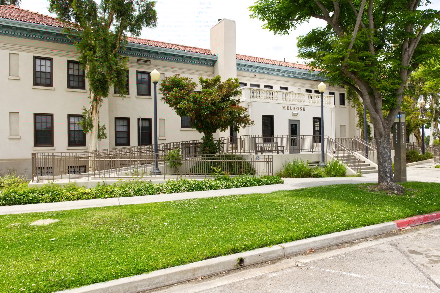 a building with a fence and trees
