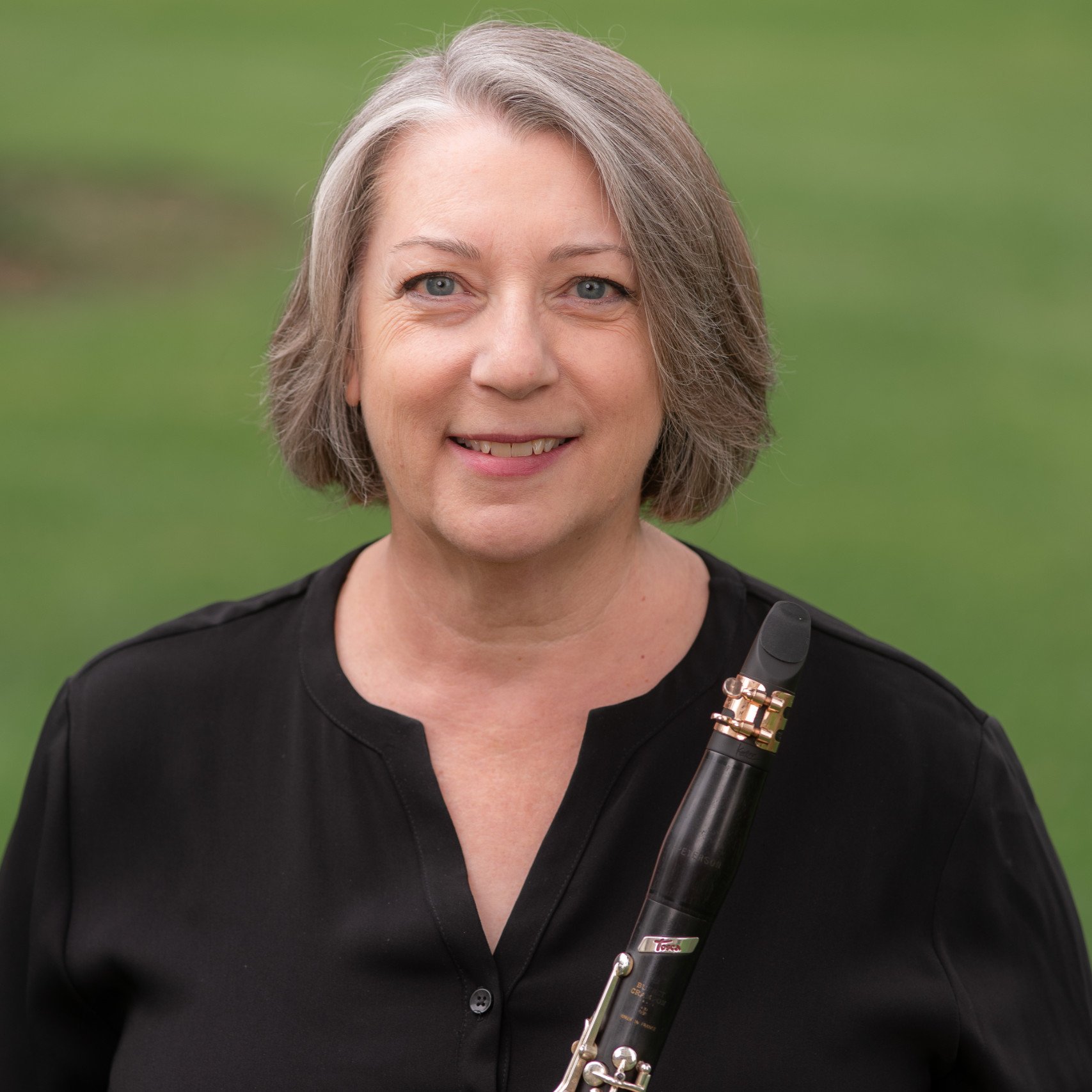 a woman holding a clarinet