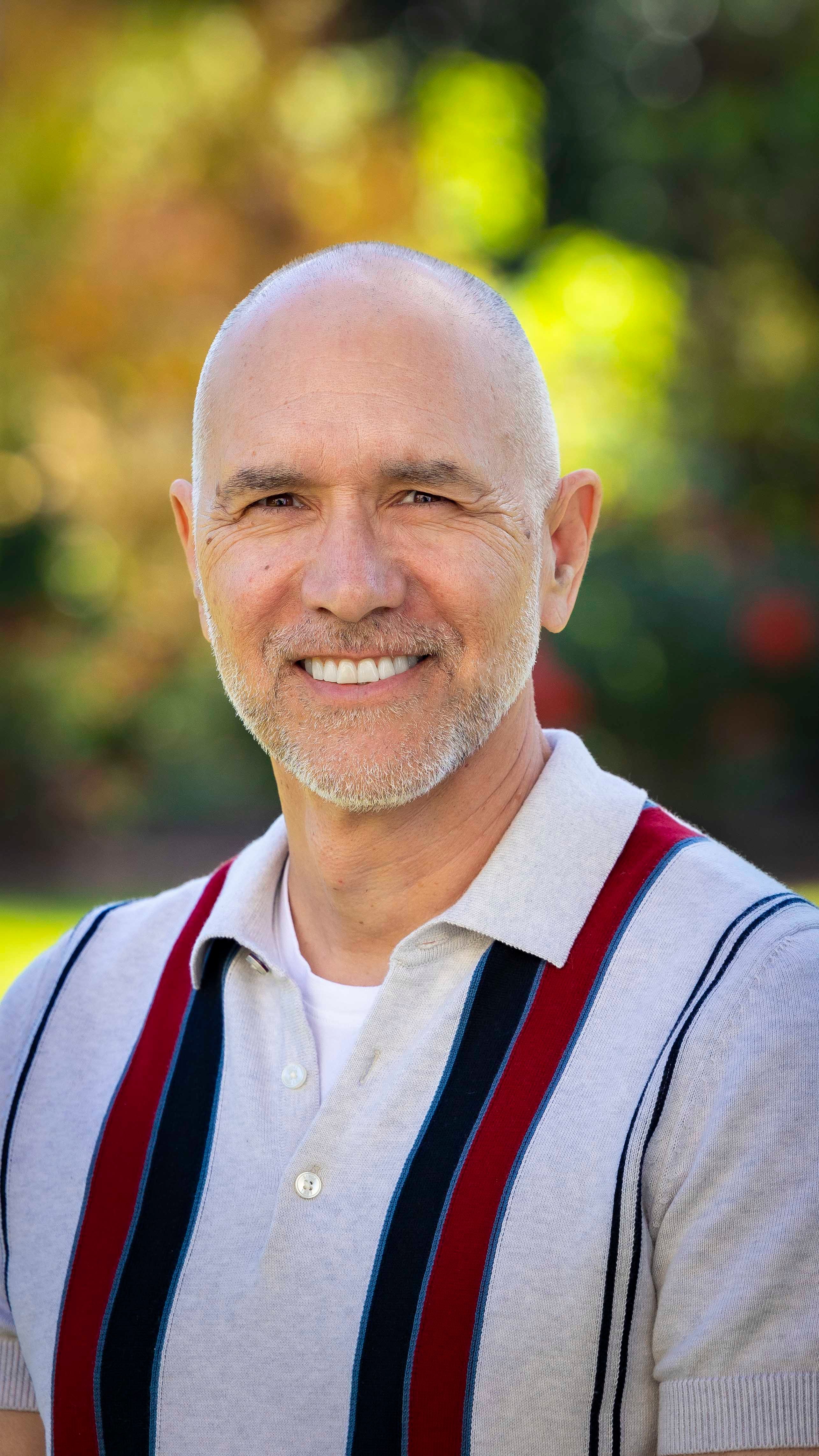a man smiling with sand on his beard