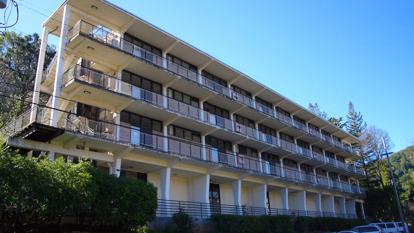 a building with balconies and a fence