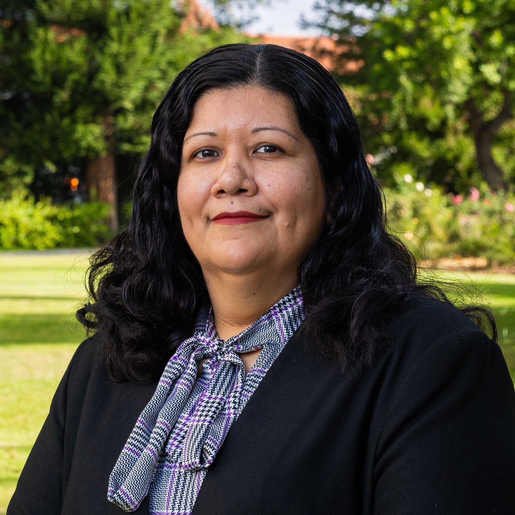 a person with long black hair and a black shirt