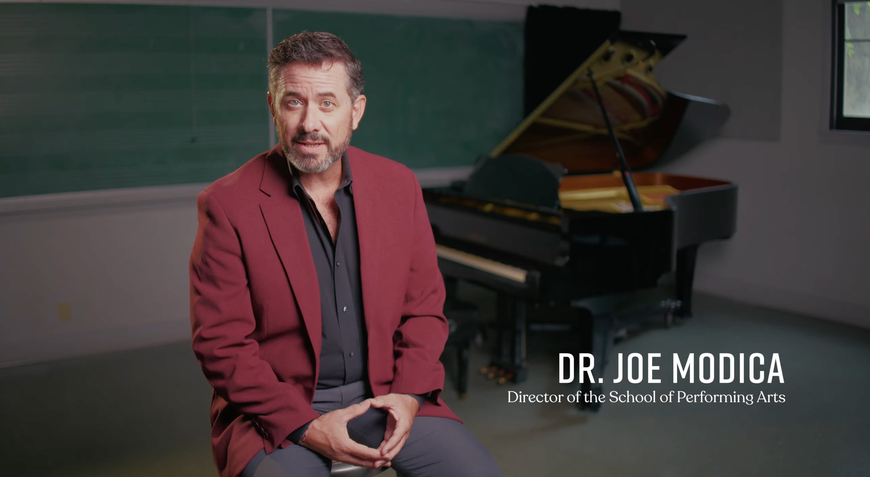a man sitting in front of a piano