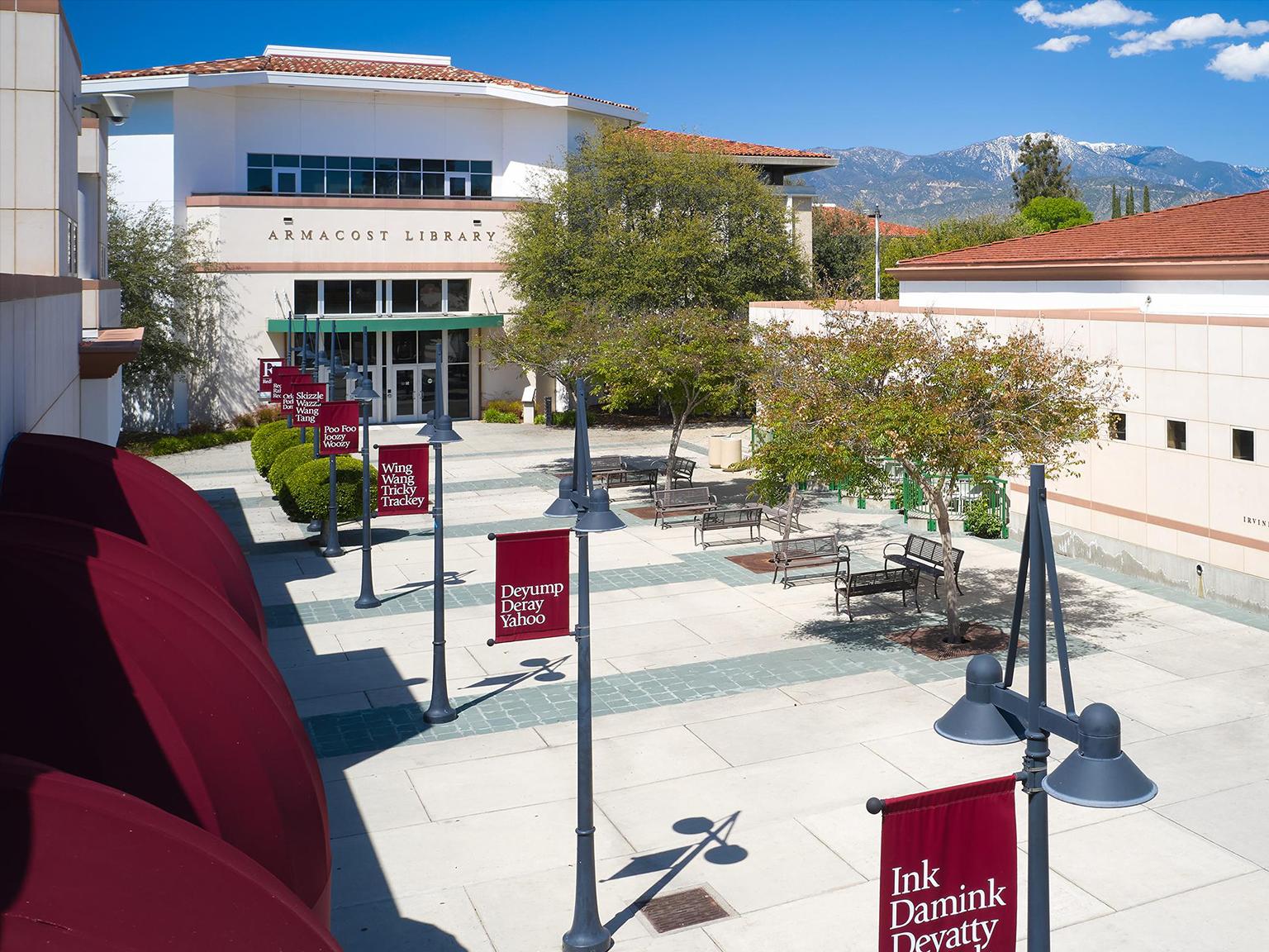 a building with red signs and trees