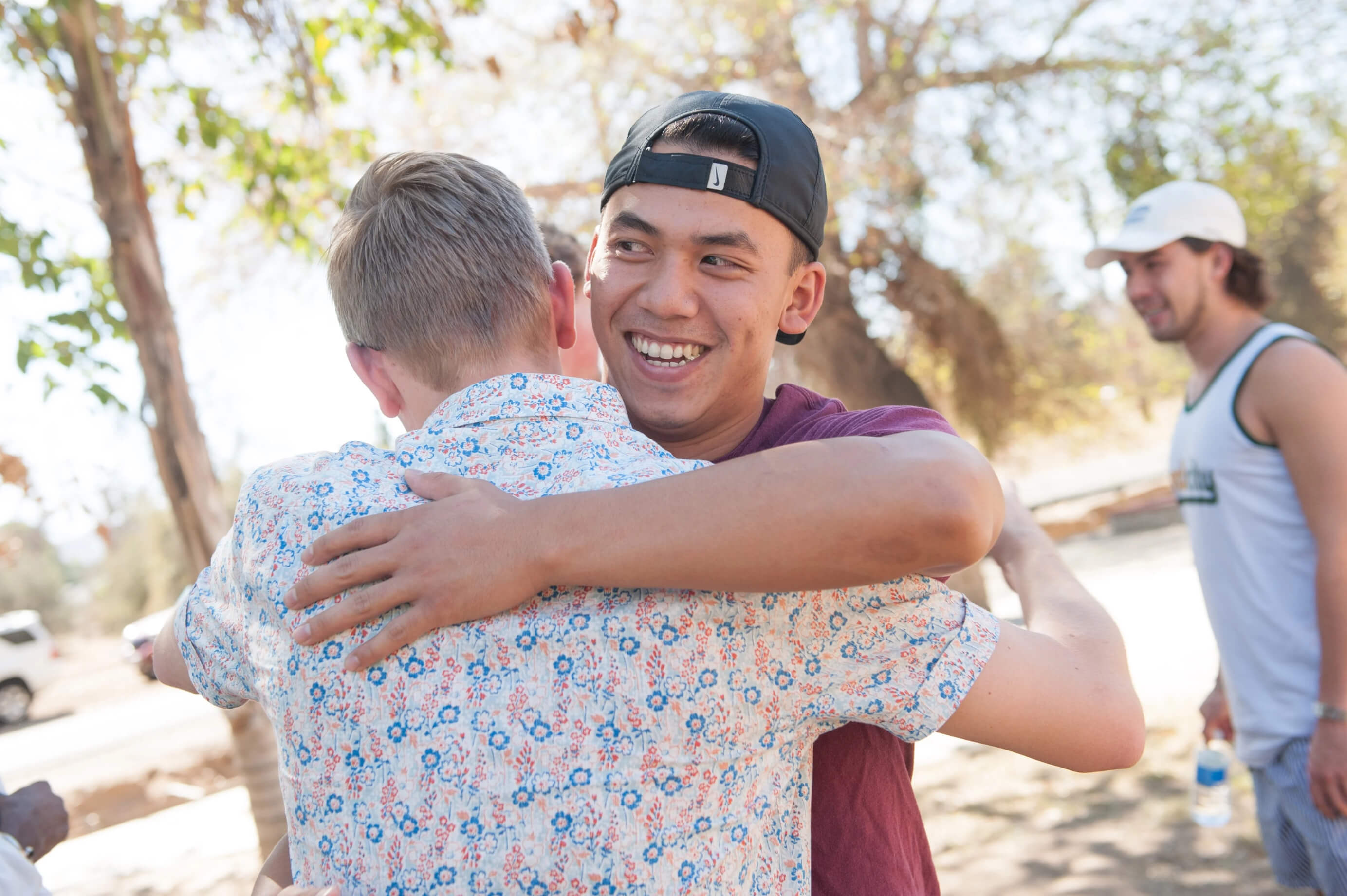 a man hugging another man