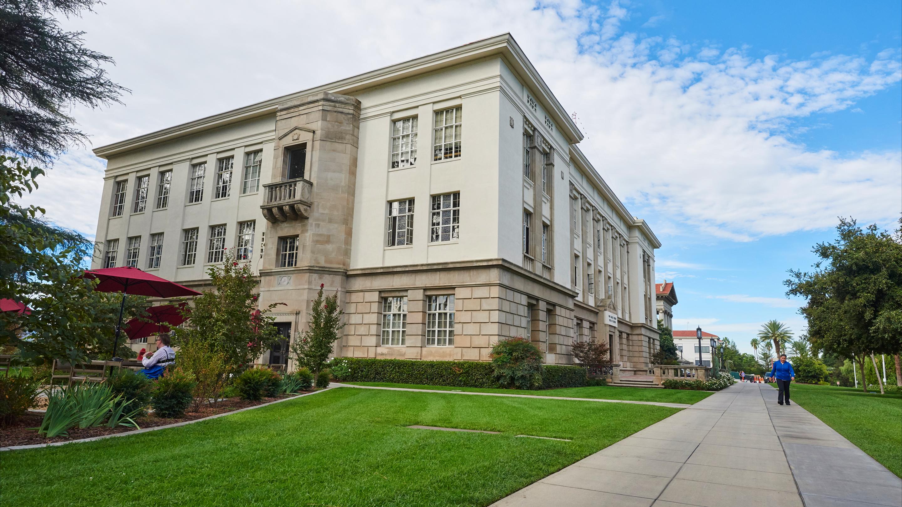 a building with a lawn and a sidewalk