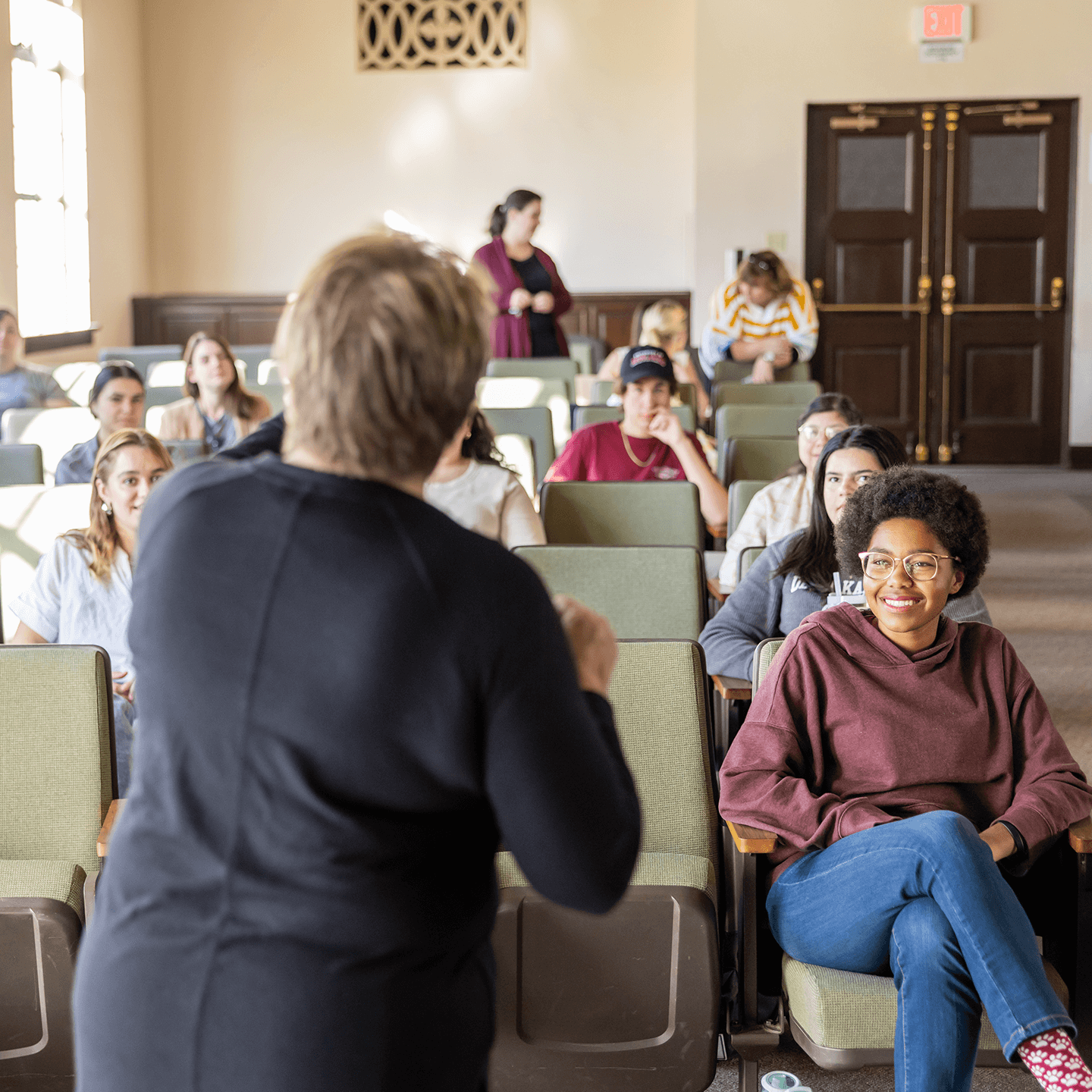 a person standing in front of a group of people