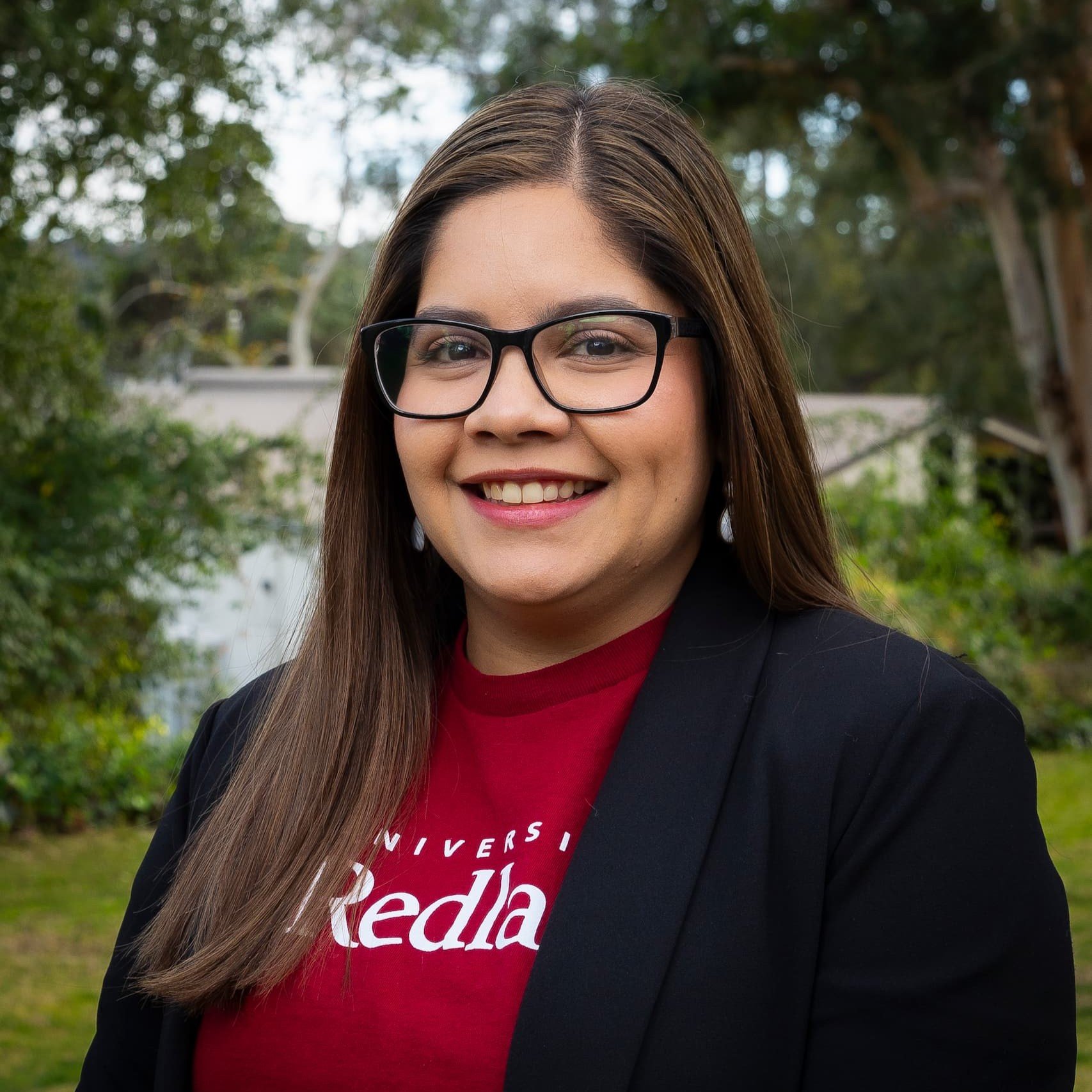 a woman wearing glasses and a black jacket