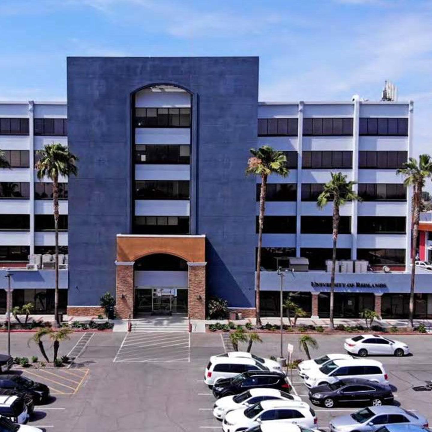 a building with many cars parked in front of it