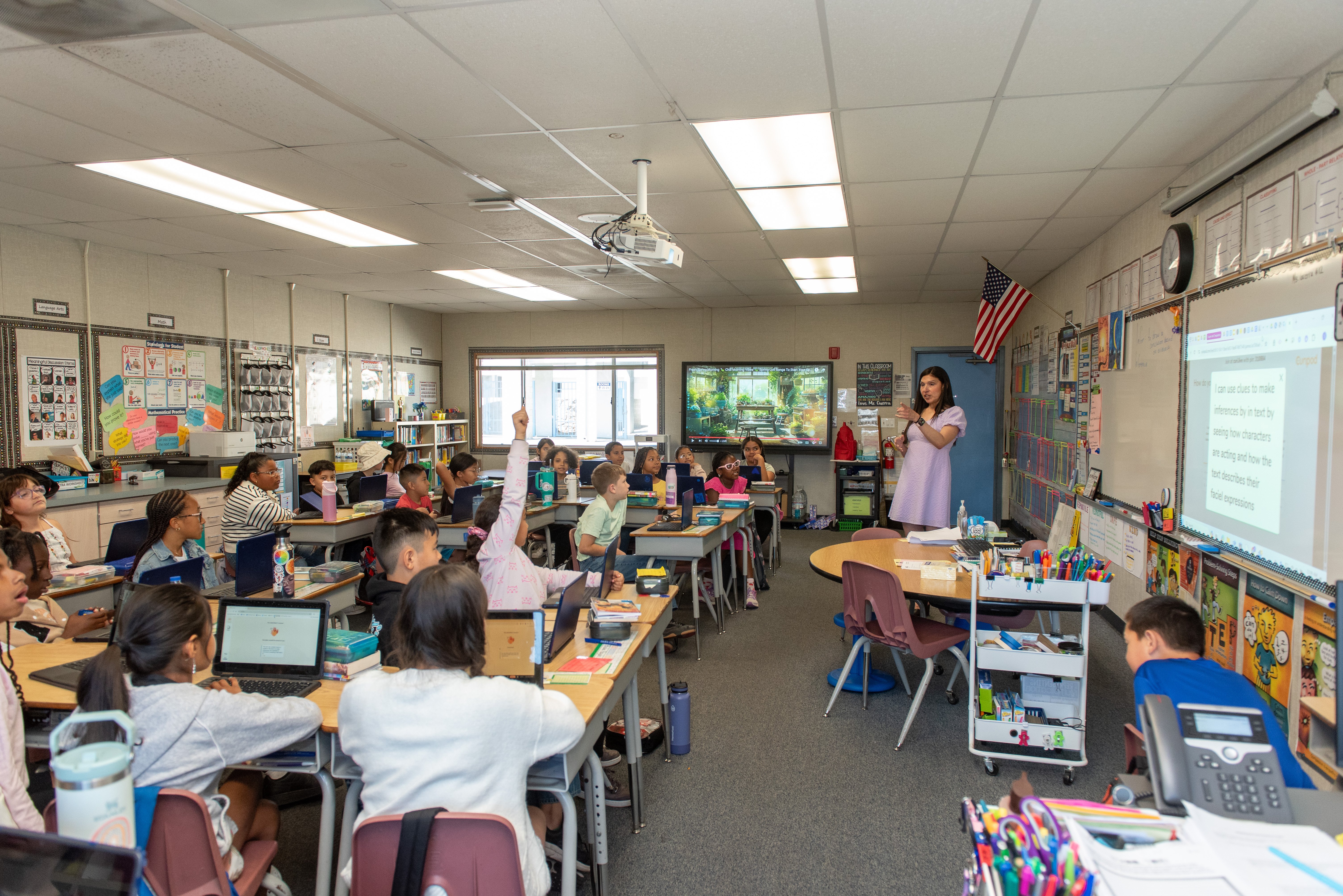a woman standing in front of a group of students in a classroom