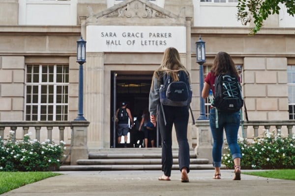 a group of people walking into a building