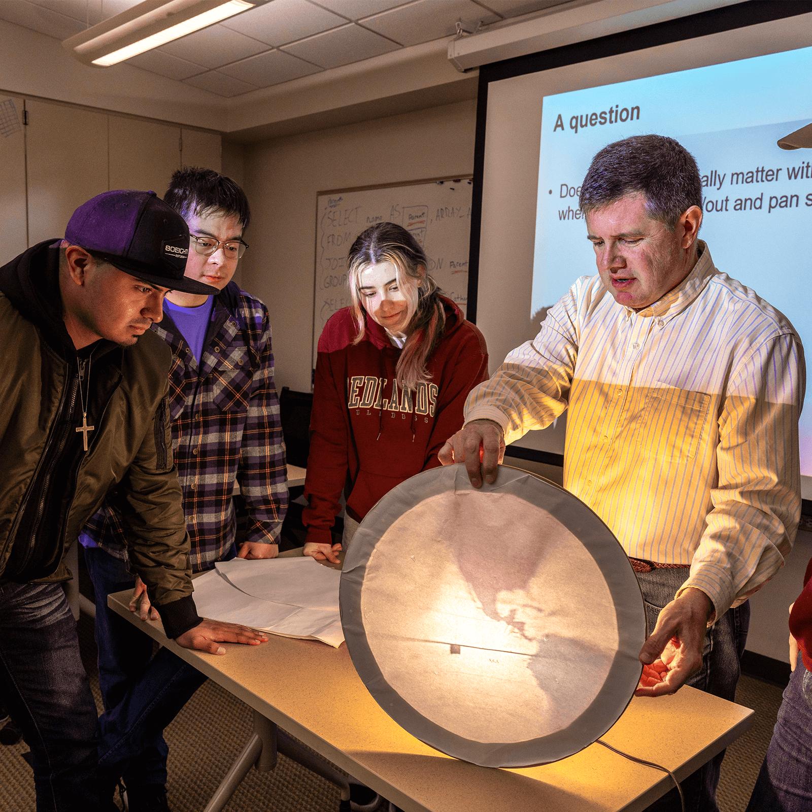 a group of people standing around a table