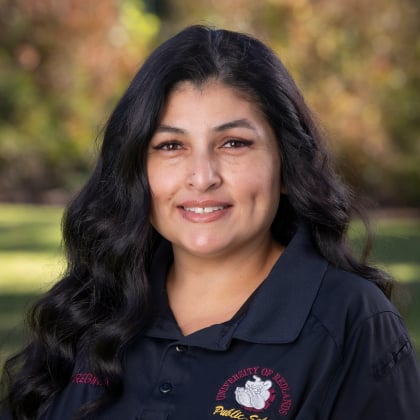a woman with long black hair smiling