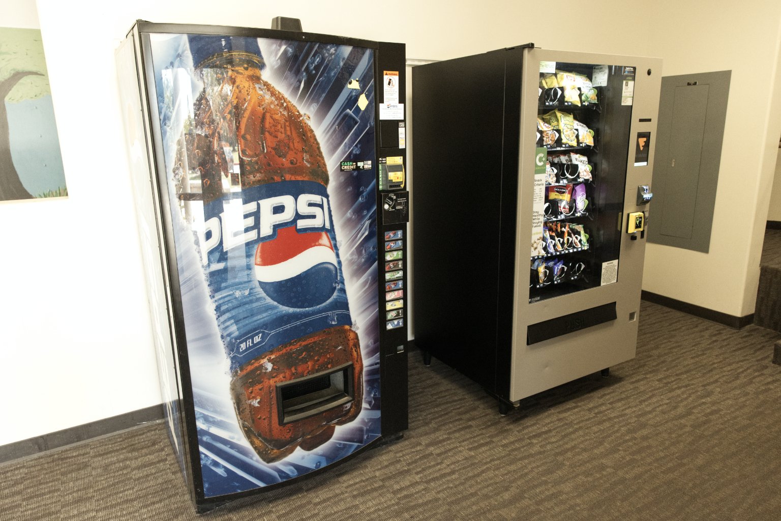 a vending machine with a soda bottle and a beverage vending machine