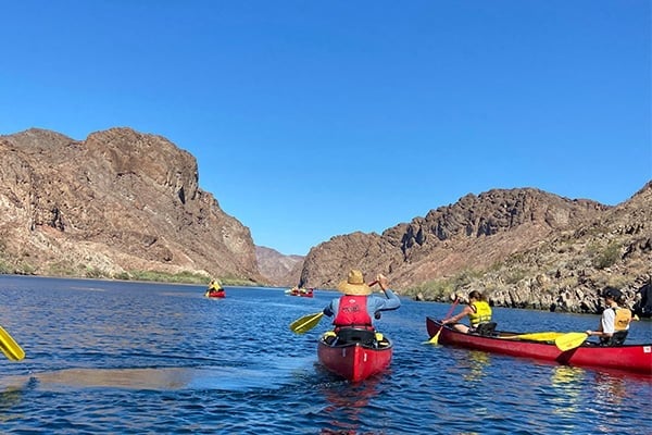 people canoeing on a lake