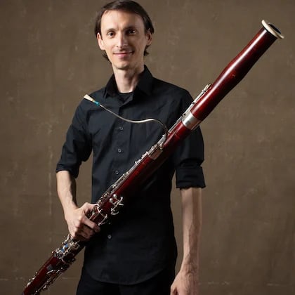 a man holding a bassoon