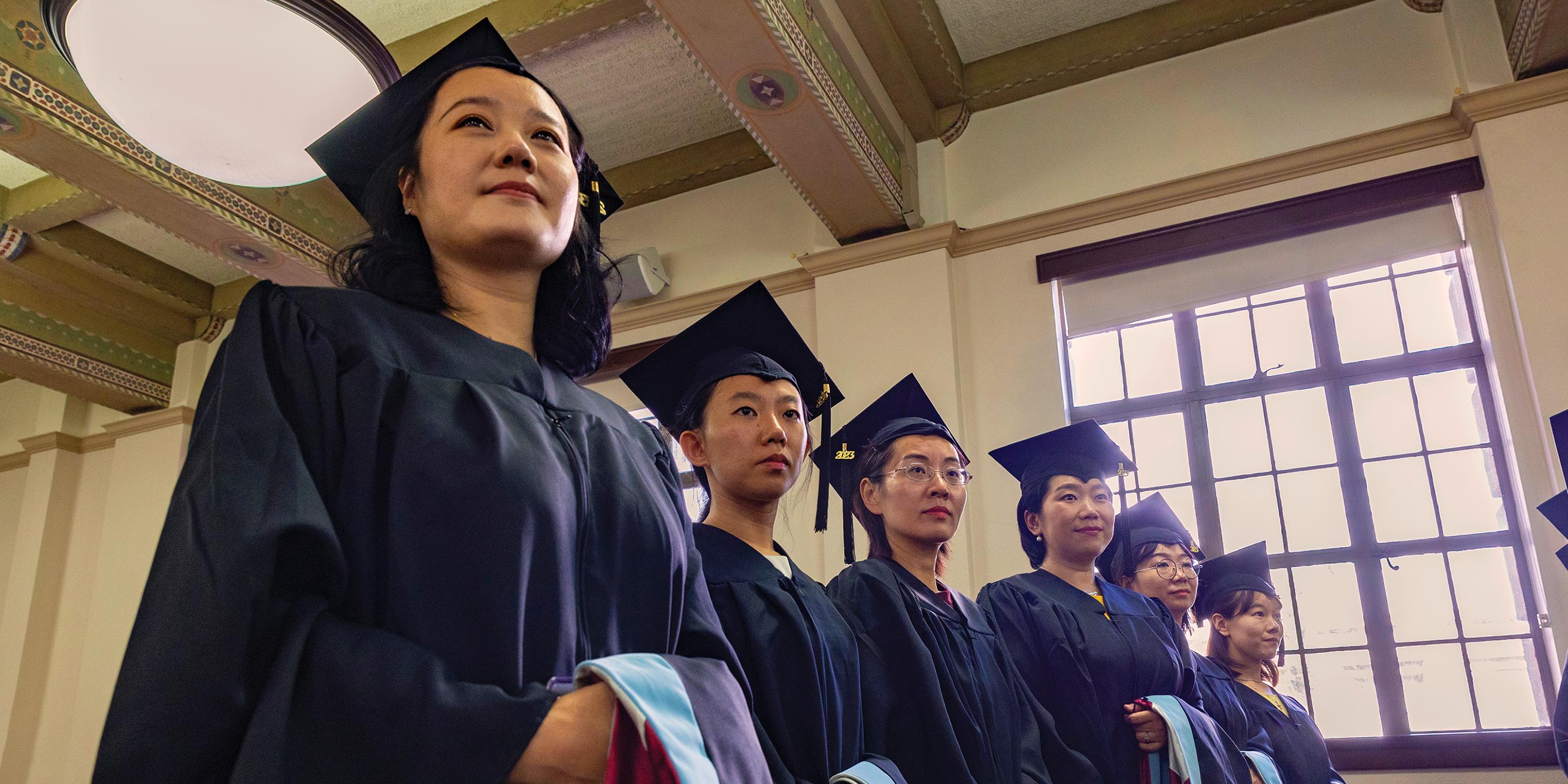 a group of women in graduation gowns
