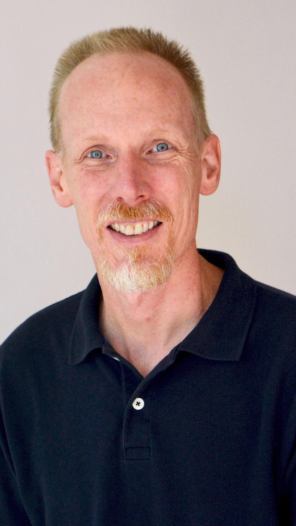 a man with a beard and mustache wearing a black shirt