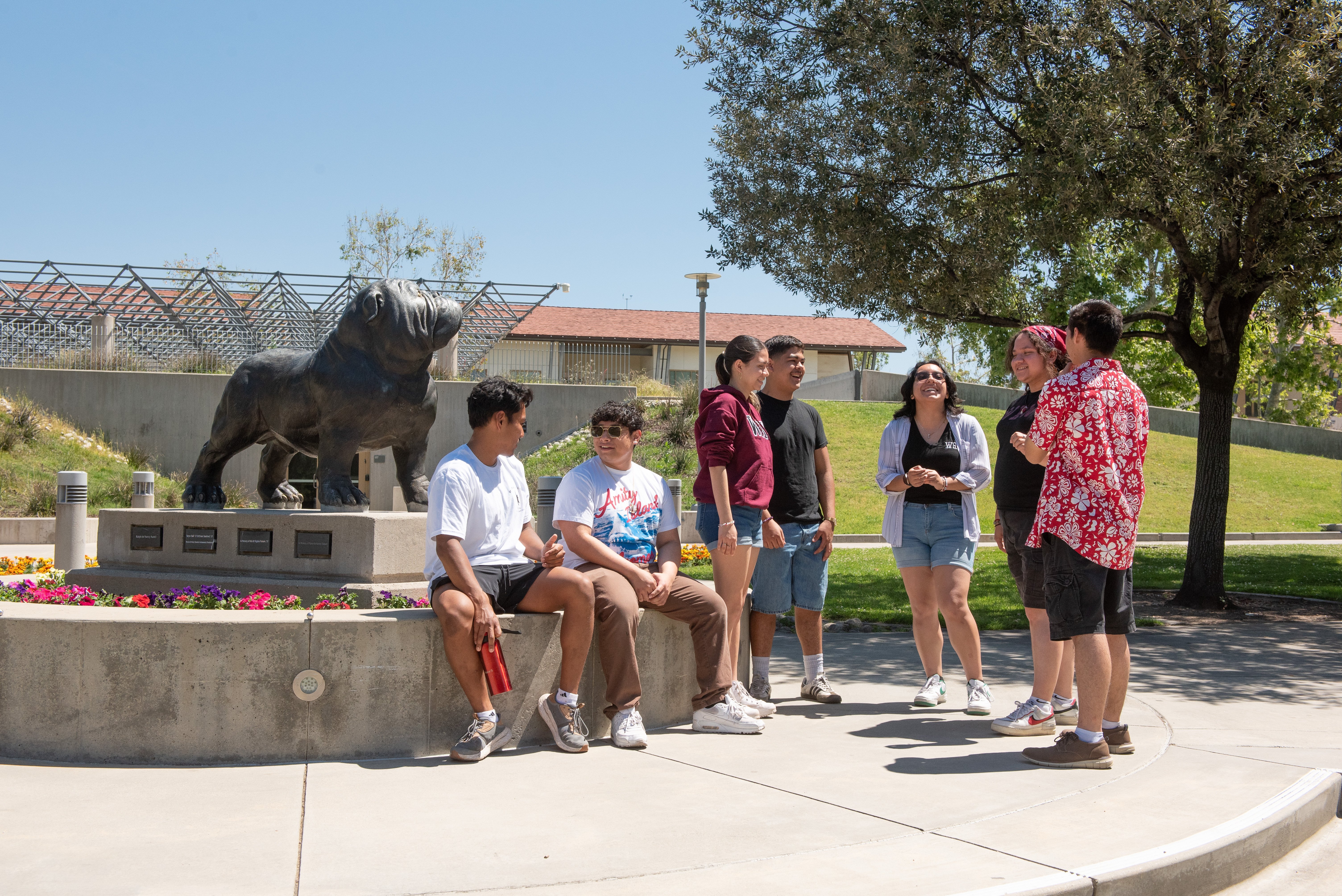 a group of people standing around a statue
