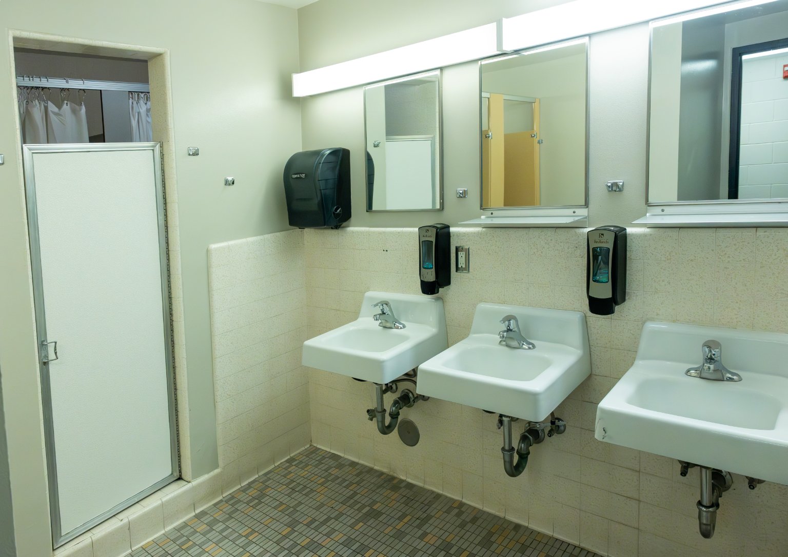 a bathroom with sinks and mirrors
