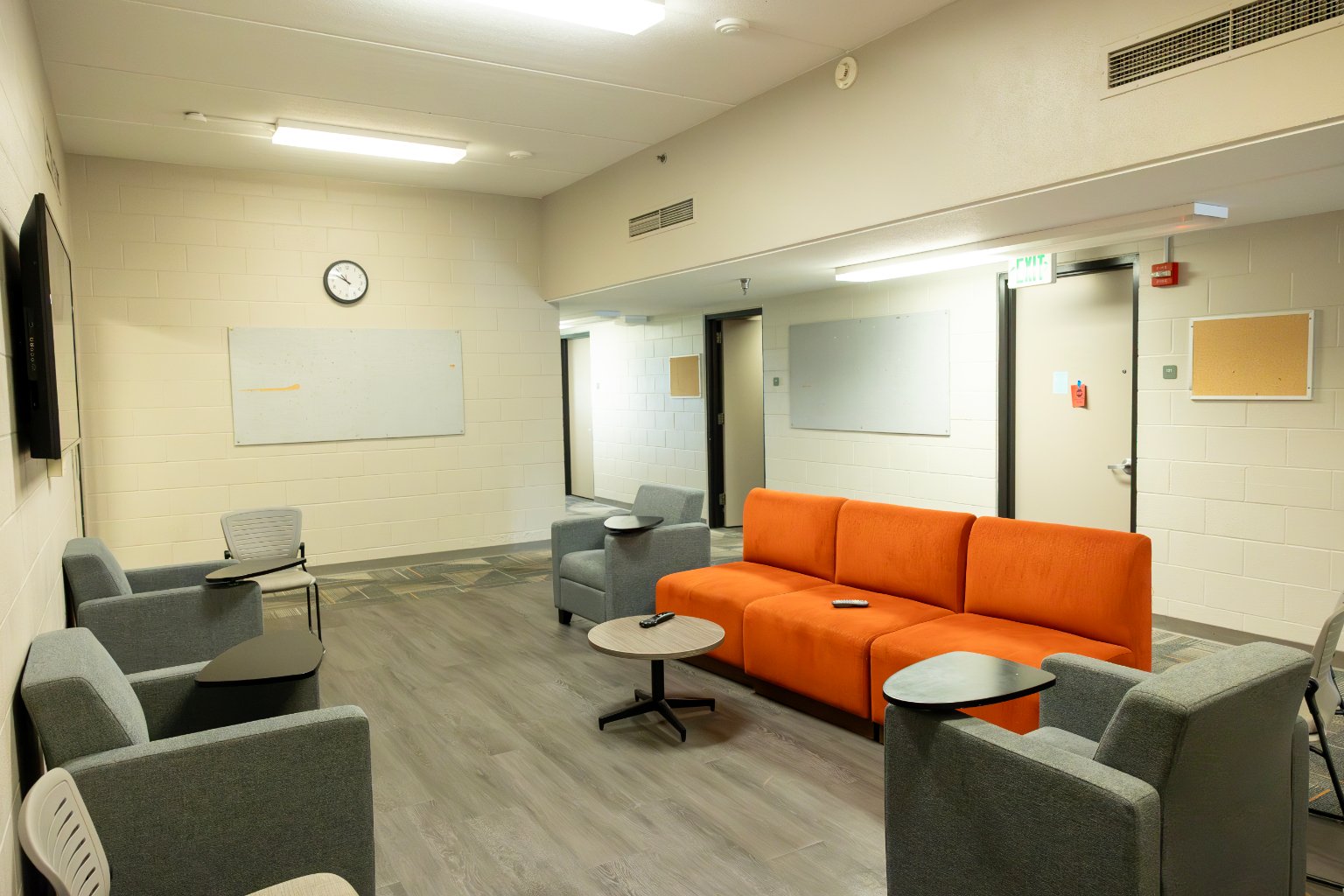 a room with a couch and chairs