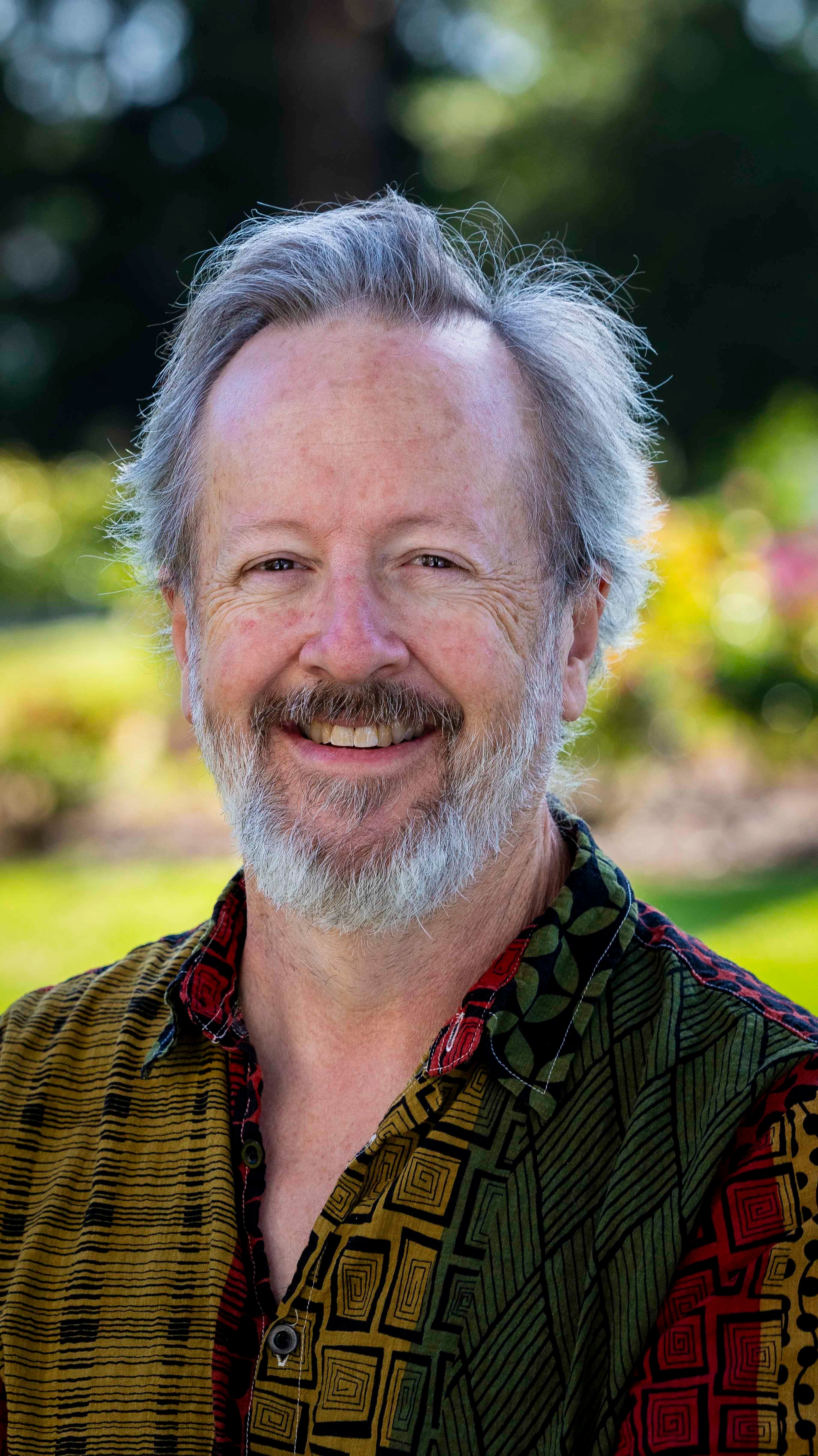 a man with a beard smiling