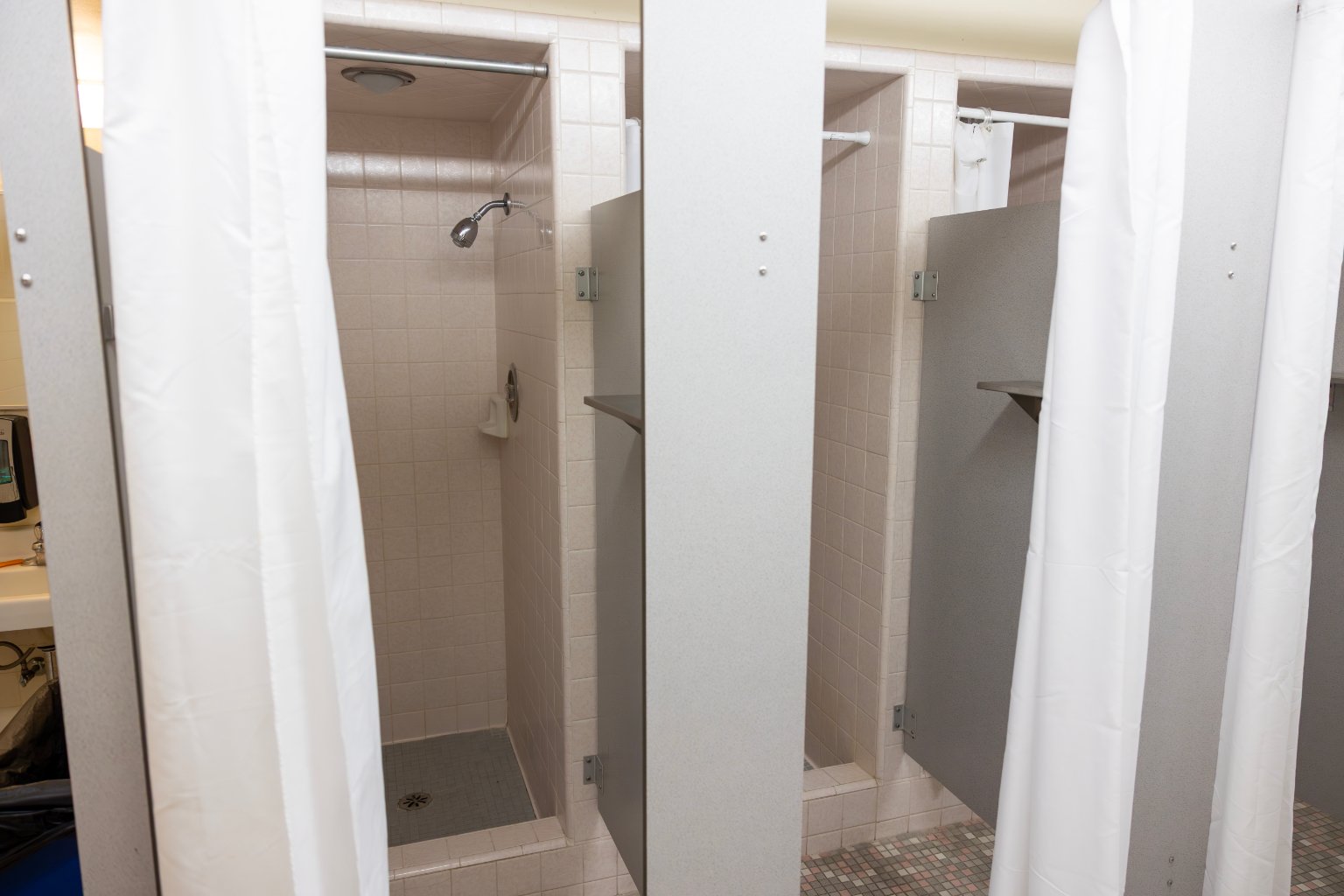 a shower stall with shower curtain