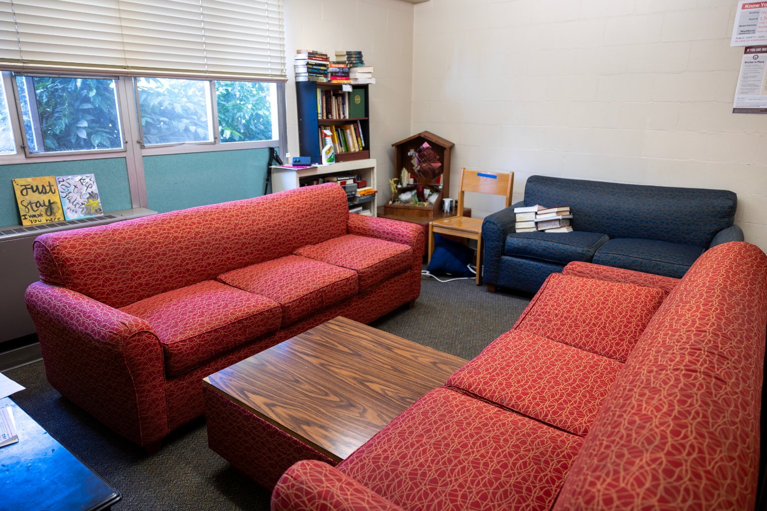 a room with red couches and a table