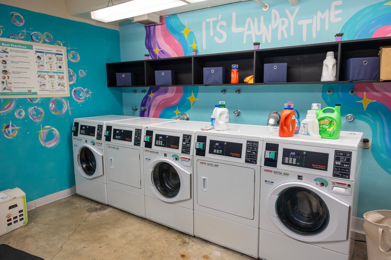 a laundry room with washers and dryers