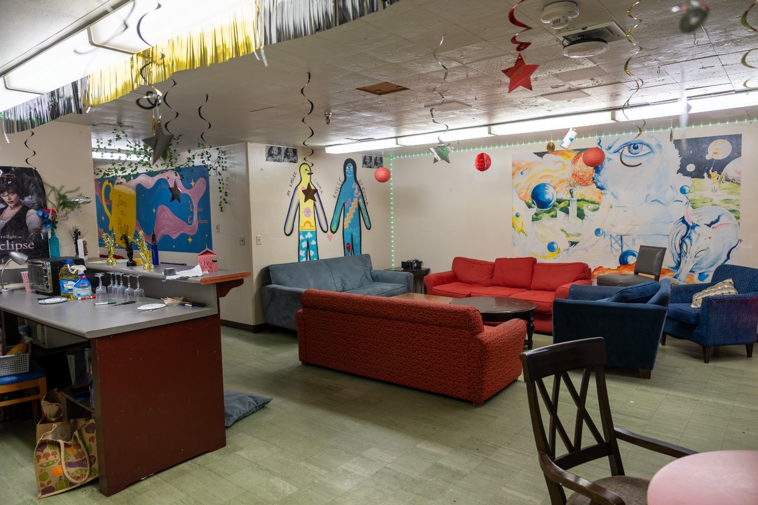 a room with couches and a bar