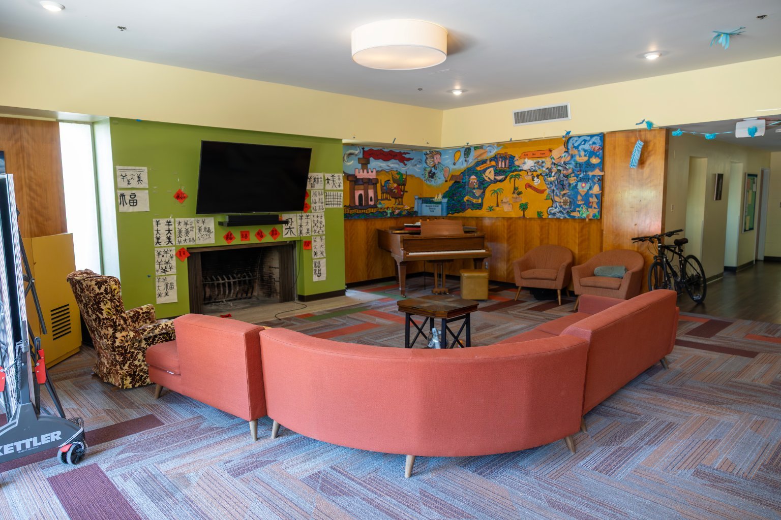 a room with couches and a piano