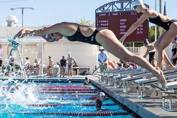 a woman diving into a pool