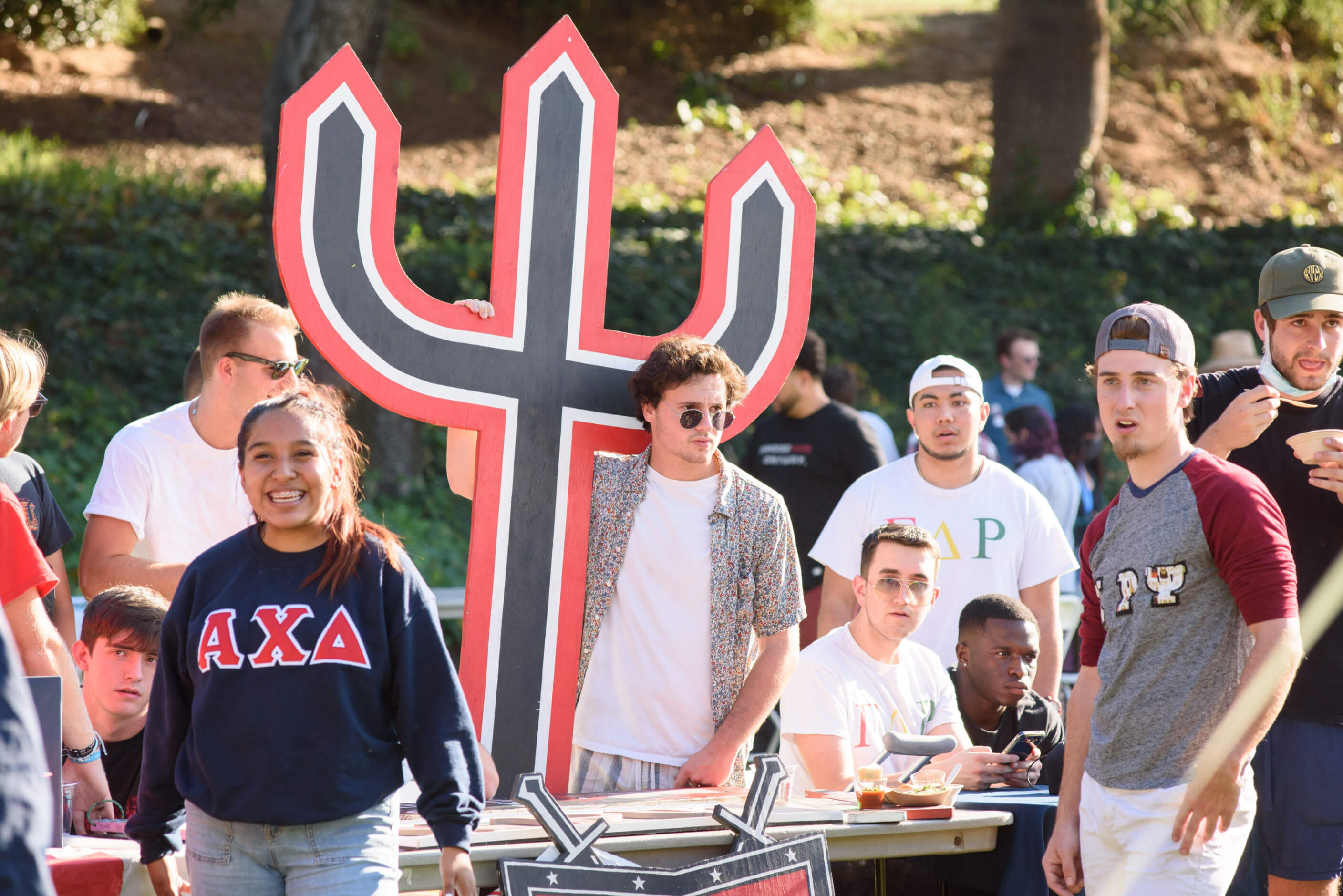 a group of people standing next to a table